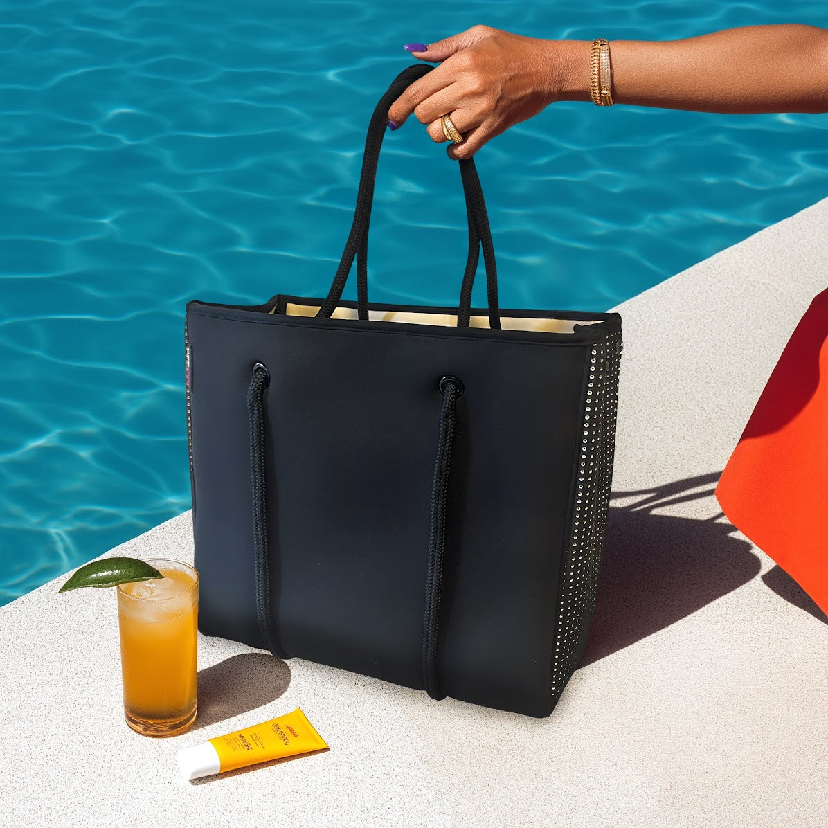 Woman carrying lightweight neoprene handbag