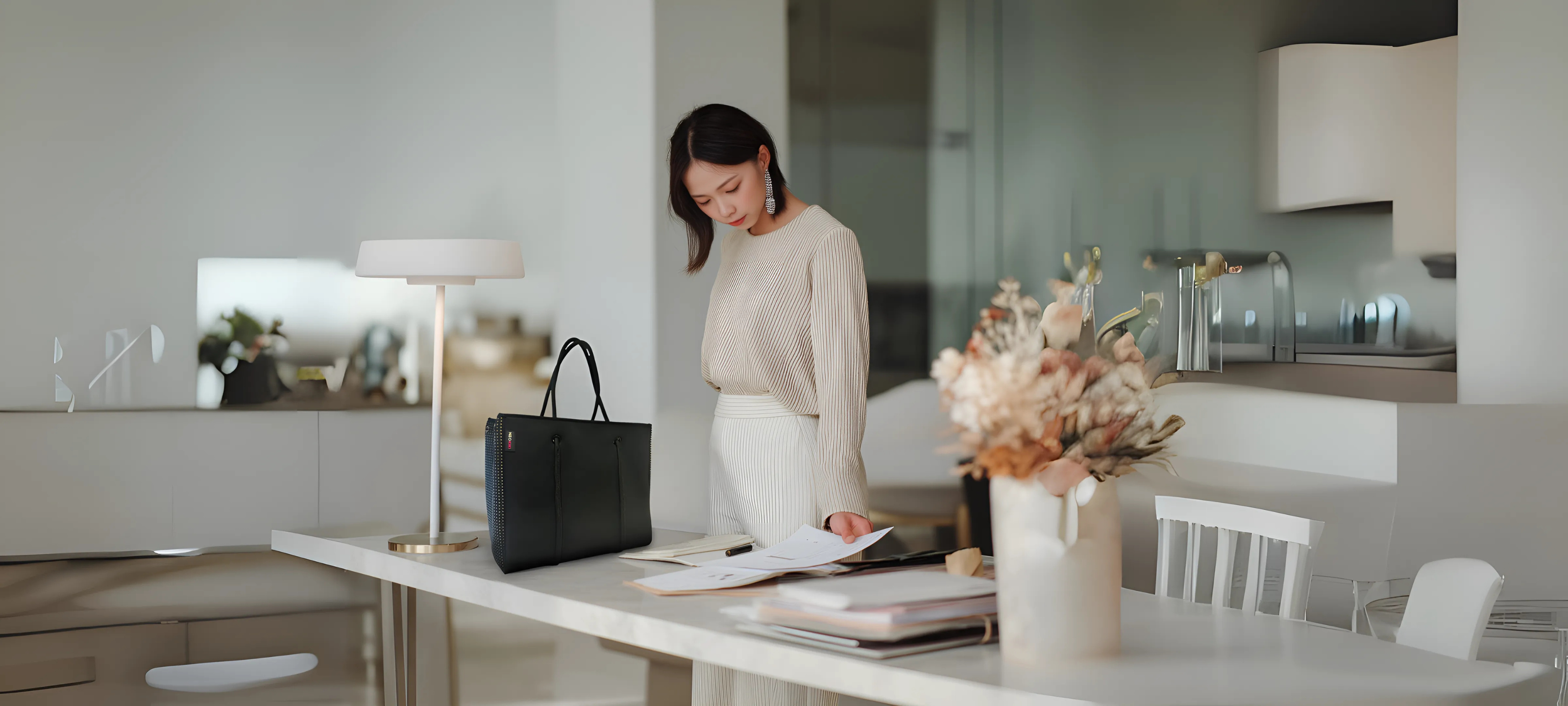 Woman carrying lightweight neoprene handbag