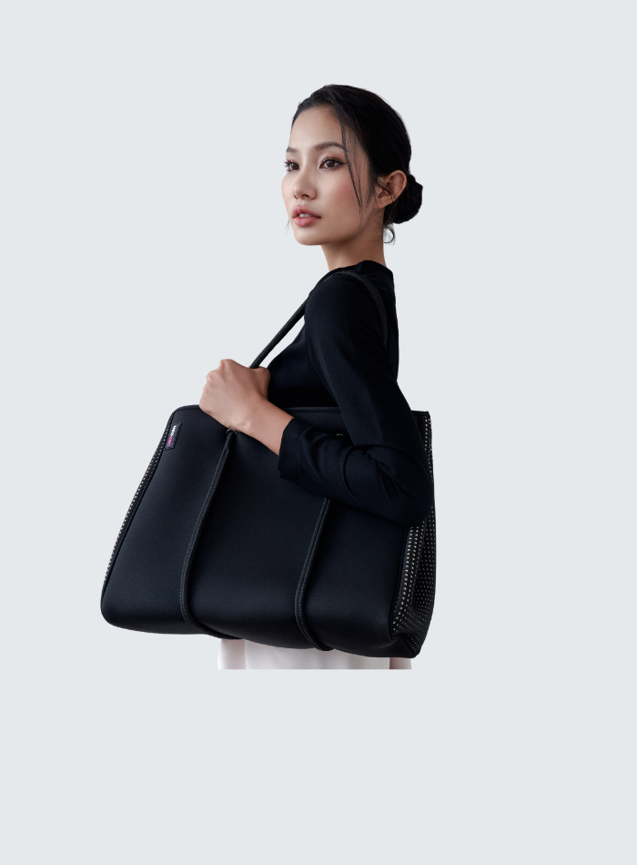 Woman carrying lightweight neoprene handbag